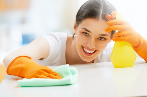 Staff member following safe carpet cleaning procedures